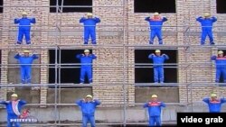 Construction workers take part in Turkmenistan's state-ordered Week of Health and Happiness in this video grab from Turkmen state television.