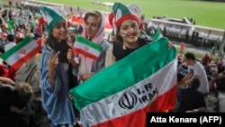 Iranian women watch a soccer match at Azadi Stadium in Tehran in 2018, one of the rare times they were allowed inside a stadium while men competed.