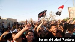 People gather during a protest near the building of government office in Basra, Iraq September 6, 2018. 