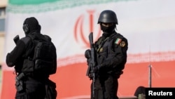 Members of the Iranian police attend a pro-government rally in Tehran on January 12