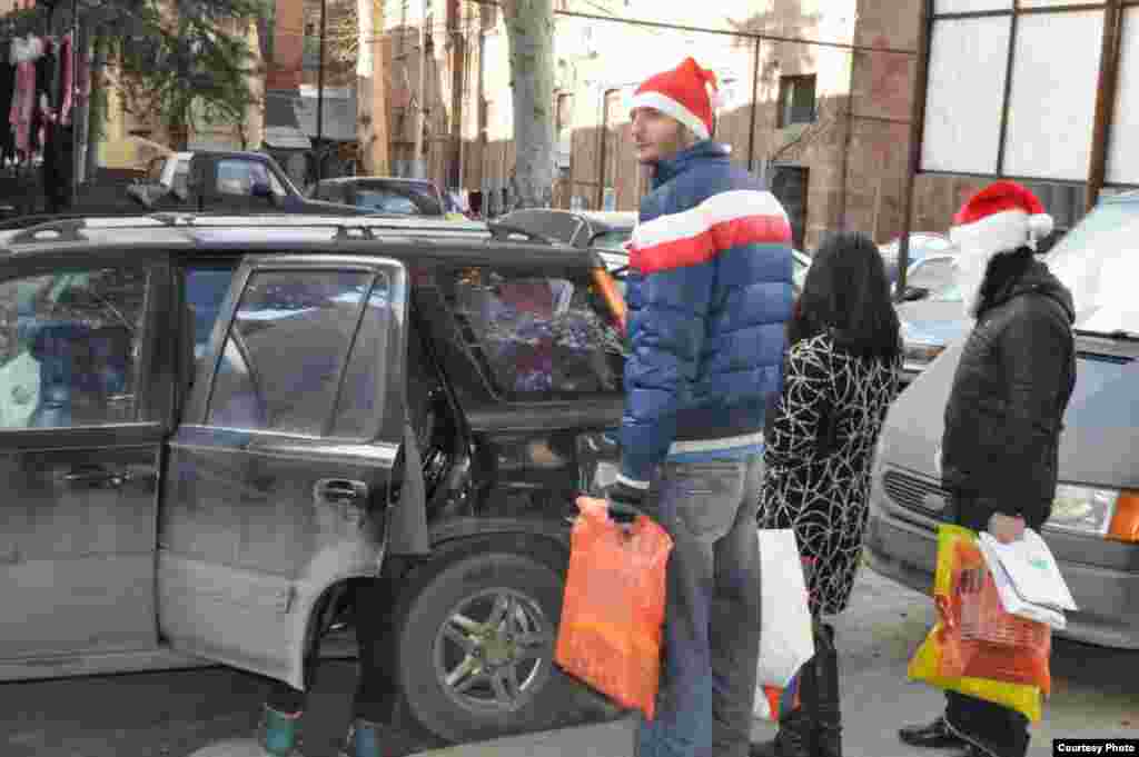 Volunteers put on their Santa hats to bring presents for the children at the Railroad Hospital.