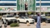 A man walks past a banner of Saudi Crown Prince Mohammed bin Salman displayed on a commercial building in Riyadh. 