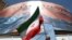 A man holds an Iranian flag near an anti-U.S. billboard depicting U.S. President Donald Trump and the Strait of Hormuz, in Tehran
