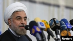 Iran -- President-elect Hassan Rohani speaks to the media following a visit to the Khomeini mausoleum in Tehran, 16Jun2013