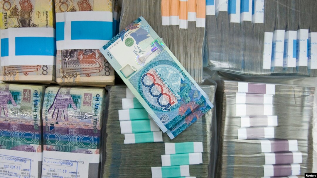 Tenge banknotes are seen at a bank branch in Almaty (file photo)