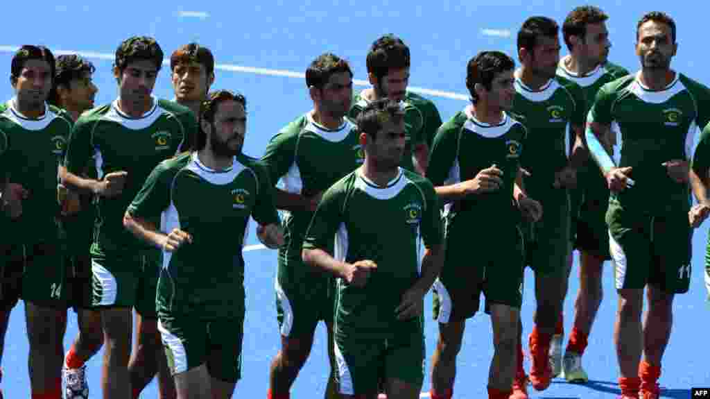 U.K. - Field hockey players from Pakistan warm-up during a training session at the Old Loughtonians Hockey Club at Chigwell on the outskirts of London, 24Jul2012