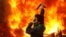 An opposition supporter stands near a police motorcycle set on fire during clashes with security forces in Tehran on December 27.