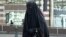 A Muslim woman dressed in niqab walks through the streets of Brussels.