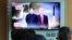People watch a TV screen showing file footage of U.S. President Donald Trump, right, and North Korean leader Kim Jong Un during a news program at Seoul Railway Station in Seoul, South Korea, Monday, June 11, 2018.