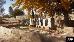 A man stands alongside the graves of some of the 16 Afghan villagers who were killed in the March 2012 near Kandahar.