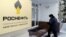 An employee of the Russian oil company Rosneft enters the company's headquarters in Moscow on December 8. 