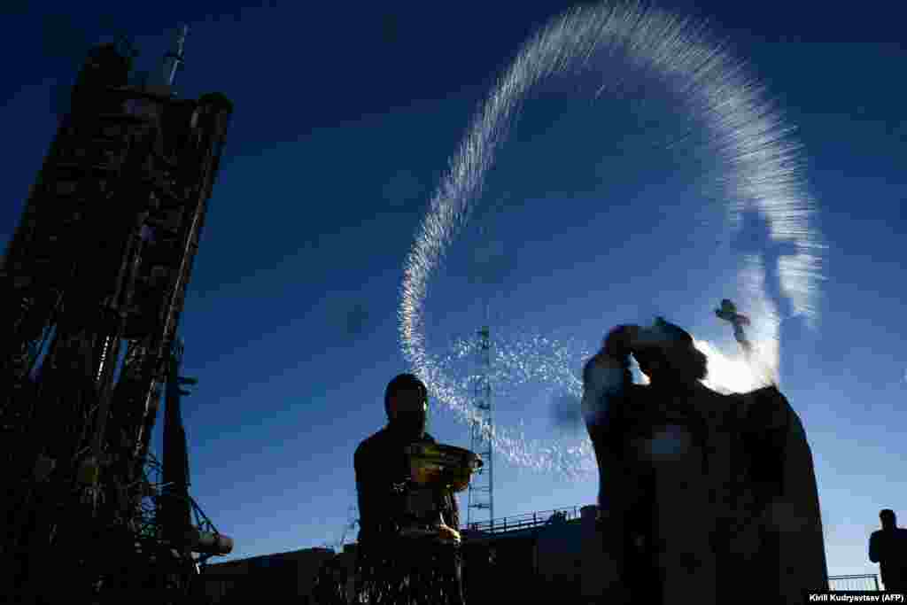 A Russian Orthodox priest blesses the Soyuz MS-11 spacecraft at the Baikonur Cosmodrome in Kazakhstan on December 2. One Russian cosmonaut and two astronauts from the United States and Canada are set to board the first manned mission to the International Space Station (ISS) since an aborted launch in October. (AFP/Kirill Kudryavtsev)