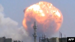 SYRIA -- An image grab taken from a video uploaded on Youtube on 01Aug13 allegedly shows smoke and fire billowing from buildings in Syria's central city of Homs following a blast in a regime ammunition dump which left tens dead. 