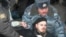 Protesters outside the Duma building are dragged away by police today