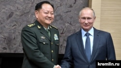 Russia President Vladimir Putin (right) meets with Chinese General Zhang Youxia in 2017 during a visit to Russia. 
