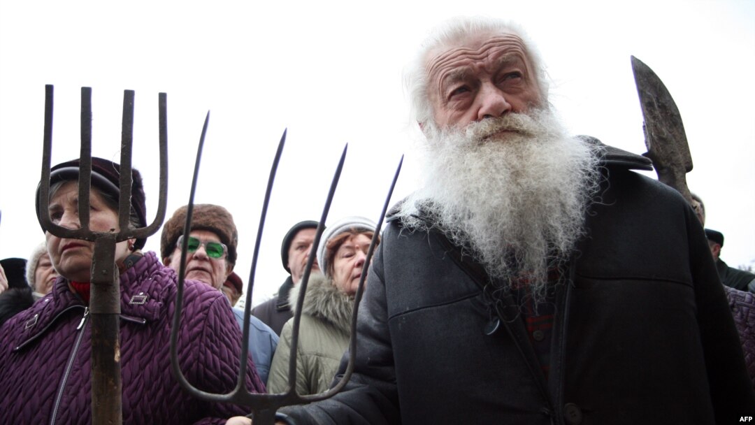 Elderly protesters rally with pitchforks and spades outside the offices of the regional governor in Donetsk.