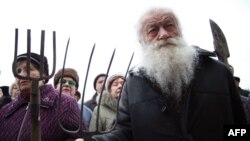 Elderly protesters rally with pitchforks and spades outside the offices of the regional governor in Donetsk.