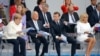 German Chancellor Angela Merkel, (from left) Portuguese President Marcelo Rebelo de Sousa, French President Emmanuel Macron, and his wife, Brigitte Macron, attend the traditional Bastille Day military parade on the Champs-Elysees Avenue in Paris on July 14.