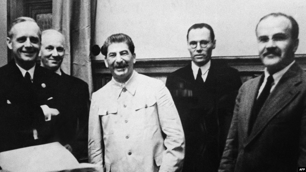 German Foreign Minister Joachim Von Ribbentrop (left), Soviet leader Joseph Stalin, and his Foreign Minister Vyacheslav Molotov (right) sign the pact in the Kremlin on August 23, 1939.