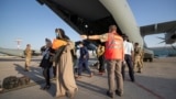 Evacuees from Afghanistan leave a German Air Force plane in Tashkent on August 26.