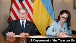 US Treasury Secretary Scott Bessant and Ukraine's First Deputy Prime Minister Yulia Svyrydenko sign minerals agreement.