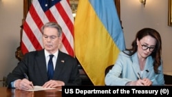 US Treasury Secretary Scott Bessant and Ukraine's First Deputy Prime Minister Yulia Svyrydenko sign the minerals agreement