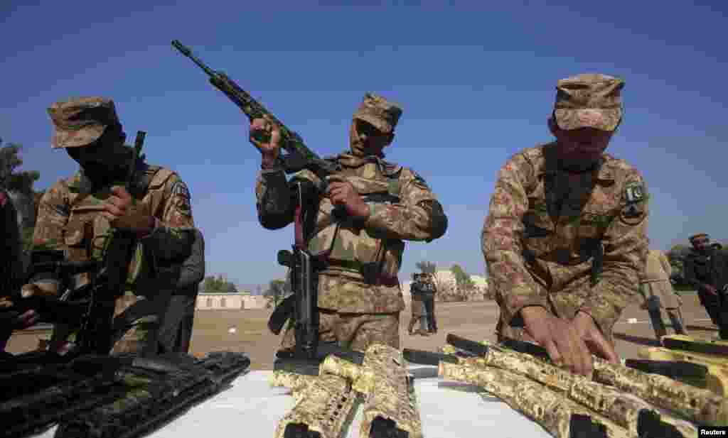 The Pakistani military claims to have eliminated major militant hideouts in northwestern Pakistan, but militant attacks have not ceased. On January 27, soldiers examine weapons seized from a warehouse in Peshawar.