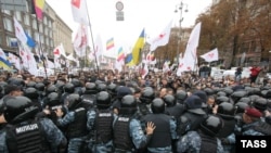 Riot police try to contain supporters of former Prime Minister Yulia Tymoshenko outside the district court in Kyiv that convicted her on October 11.