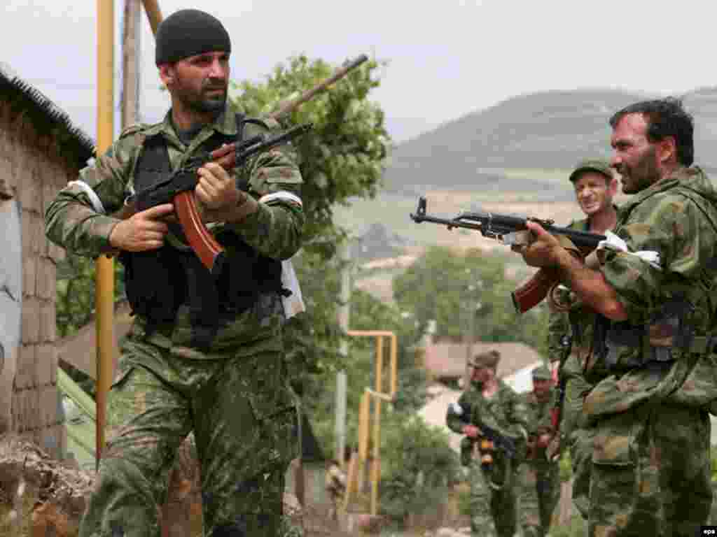 epa01442735 South Ossetian armed volunters patrol the village of Mul in South Ossetia, after checking for any remaining groups of Georgian soldiers, 12 August 2008. Russian President has announced that Russian military operation in South Ossetia and Georgia have been accomplished and Russia will cease fire if Georgian president Mikheil Saakashvili accepts the Russian proposals. EPA/STR