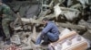 A man sits amid rubble following shelling in the town of Ganca, near the front lines in Nagorno-Karabakh. 