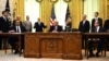 U.S. President Donald Trump (center), Kosovar Prime Minister Avdullah Hoti (right), and Serbian President Aleksandar Vucic (left) listen to U.S. Vice President Mike Pence during a signing ceremony for an economic normalization deal between the two Balkan countries in Washington on September 4. 