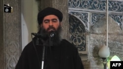 An undated video grab allegedly shows the leader of the Islamic State (IS) jihadist group, Abu Bakr al-Baghdadi at a mosque in Mosul.