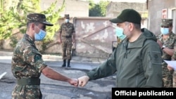 Armenian Prime Minister Nikol Pashinian fist-bumps a serviceman during a visit to one of the military units, 10 August, 2020.