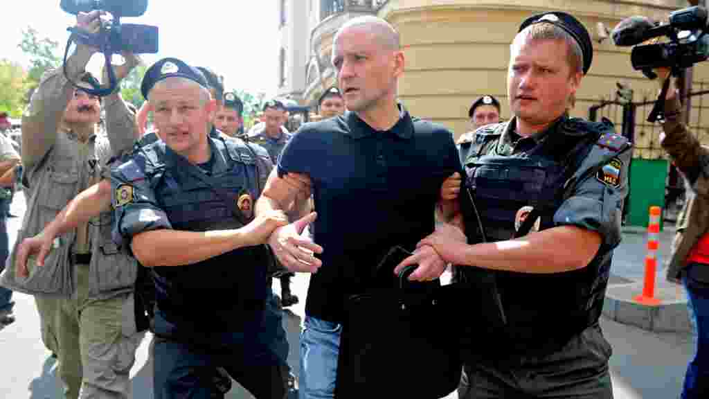 Sergei Udaltsov, leader of the opposition Left Front, is detained outside the Khamovnichesky Court in Moscow.