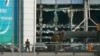 A soldier stands near broken windows after explosions at Zaventem airport near Brussels, Belgium, March 22, 2016.