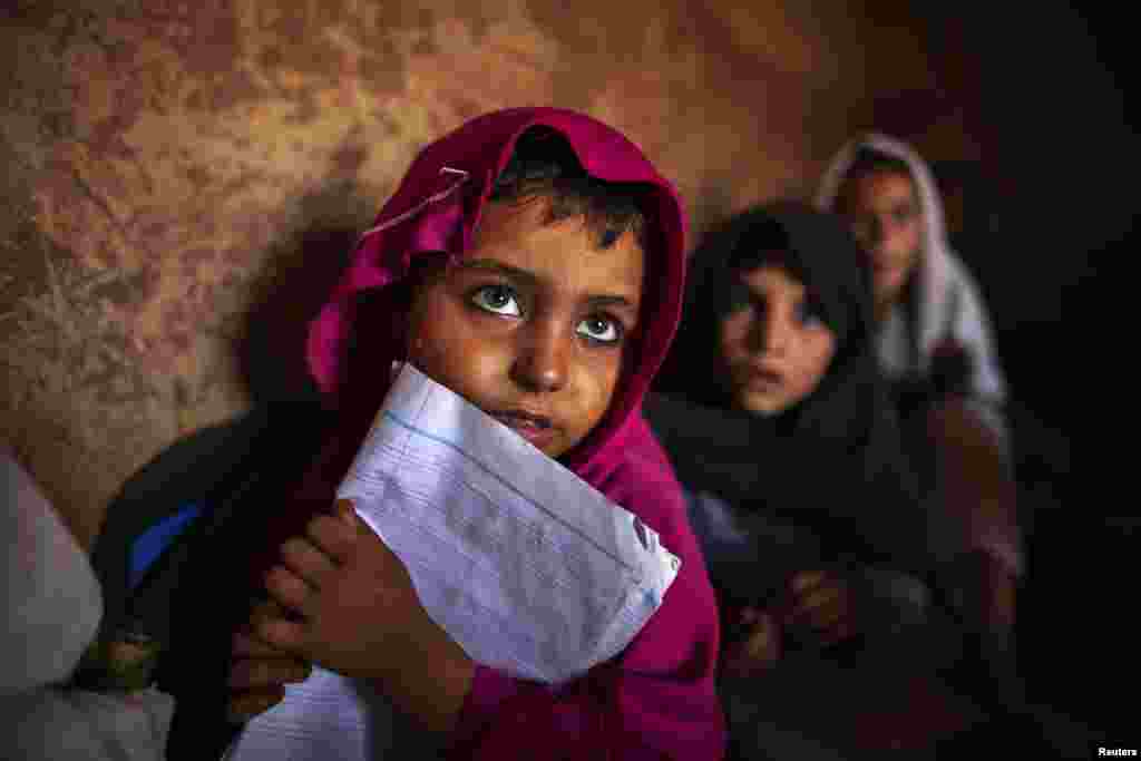 Pakistani girls attend lessons at a school in a slum on the outskirts of Islamabad. (Reuters/Zohra Bensemra)