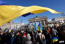 Demonstrators take part in a rally in support of Ukraine to mark the second year of Russia's military invasion of Ukraine, at the Brandenburg Gate in Berlin on February 24.