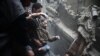 Civil-defense workers help a man from a shelter in the besieged town of Douma in eastern Ghouta on February 22.