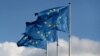 European Union flags fly outside the EU Commission headquarters in Brussels (file photo)