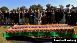 Afghan men attend the funeral of journalist Malalai Maiwand, who was shot and killed by unknown gunmen in Jalalabad on December 10.