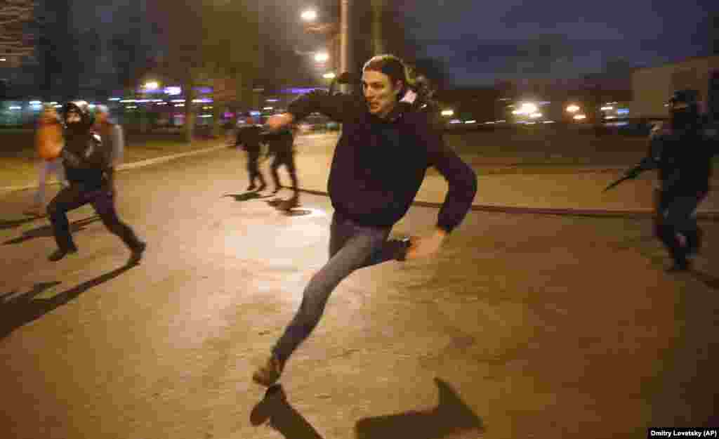 A protester runs from the police in St. Petersburg.