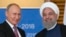 Президенты России и Ирана на саммите ШОС в китайском городе Циндао. 9 июня 2018 года