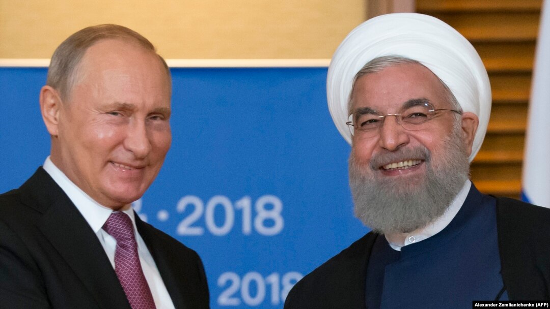 Президенты России и Ирана на саммите ШОС в китайском городе Циндао. 9 июня 2018 года