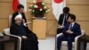 Iranian President Hassan Rouhani (L) and Japanese Prime Minister Shinzo Abe (R) attend a meeting at the prime minister's office in Tokyo on December 20, 2019. 