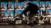 A man rides his bicycle past election posters of former Prime Minister and VMRO-DPMNE leader Nikola Gruevski in Skopje.