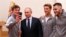 President Vladimir Putin (second left) poses for a selfie during a meeting on January 31 with Russian athletes and team members who will take part in the upcoming Winter Olympic Games as neutral athletes.