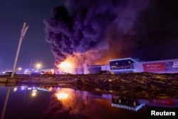 The Crocus City Hall concert venue is seen burning following the attack on March 22.