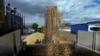 FILE PHOTO: A worker loads a truck with grain at a terminal during barley harvesting in Odesa region