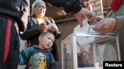 Voters cast ballots outside the capital, Bishkek, during parliamentary elections on October 10.