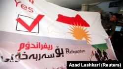 A man holds a banner in favor Kurdistan independence ahead of a planned September 25 referendum.